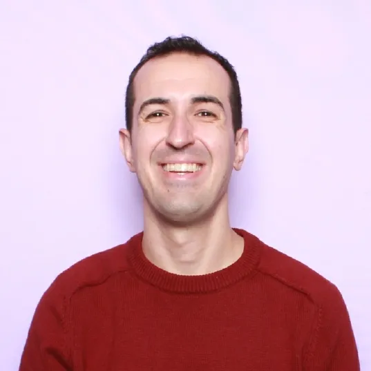 Jorge Mir Alvarez, smiling, in a red sweater